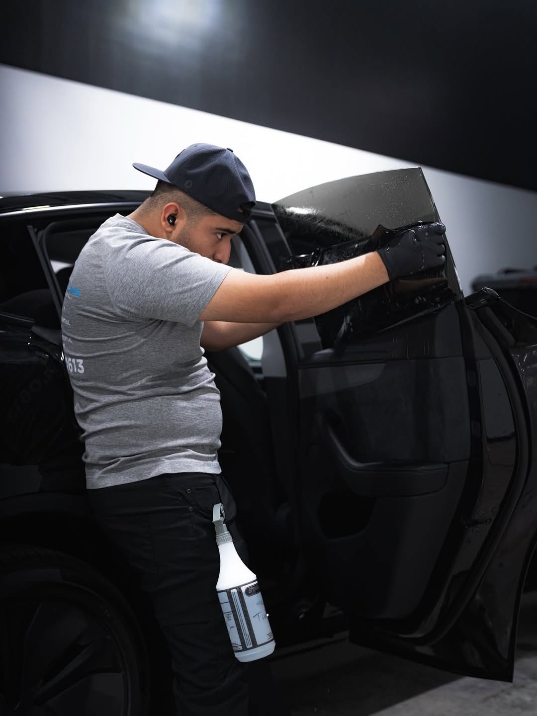 Black Diamond RGV installer applying window tint film to a door window in McAllen